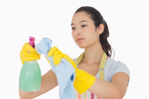Professional carpet cleaner working in a Kilburn home
